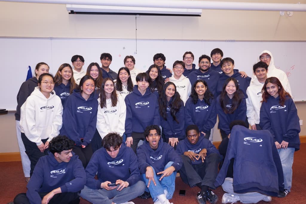 The Atlas Digital cohort in matching navy sweatshirts, gathered for a group photo.